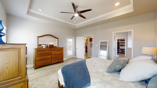 a bedroom with a large bed and a flat tv screen on a dresser