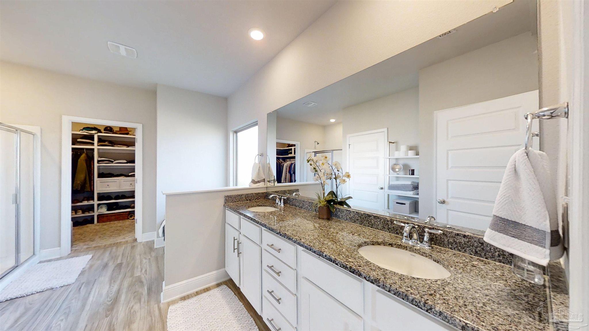 421 Apollo Avenue Gulf Shores, AL 36542 - Photo 34 of 72 a bathroom with a granite countertop sink and a mirror