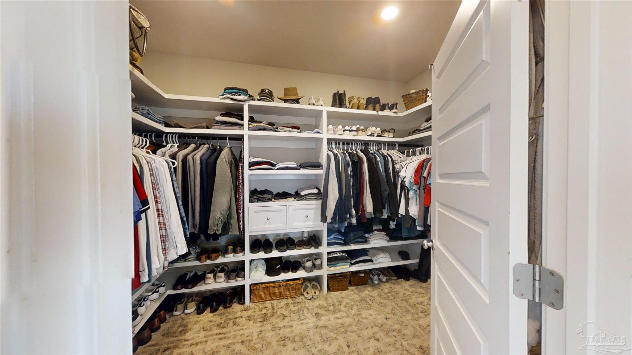 421 Apollo Avenue Gulf Shores, AL 36542 - Photo 38 of 72 a view of walk in closet with clothes and shoes