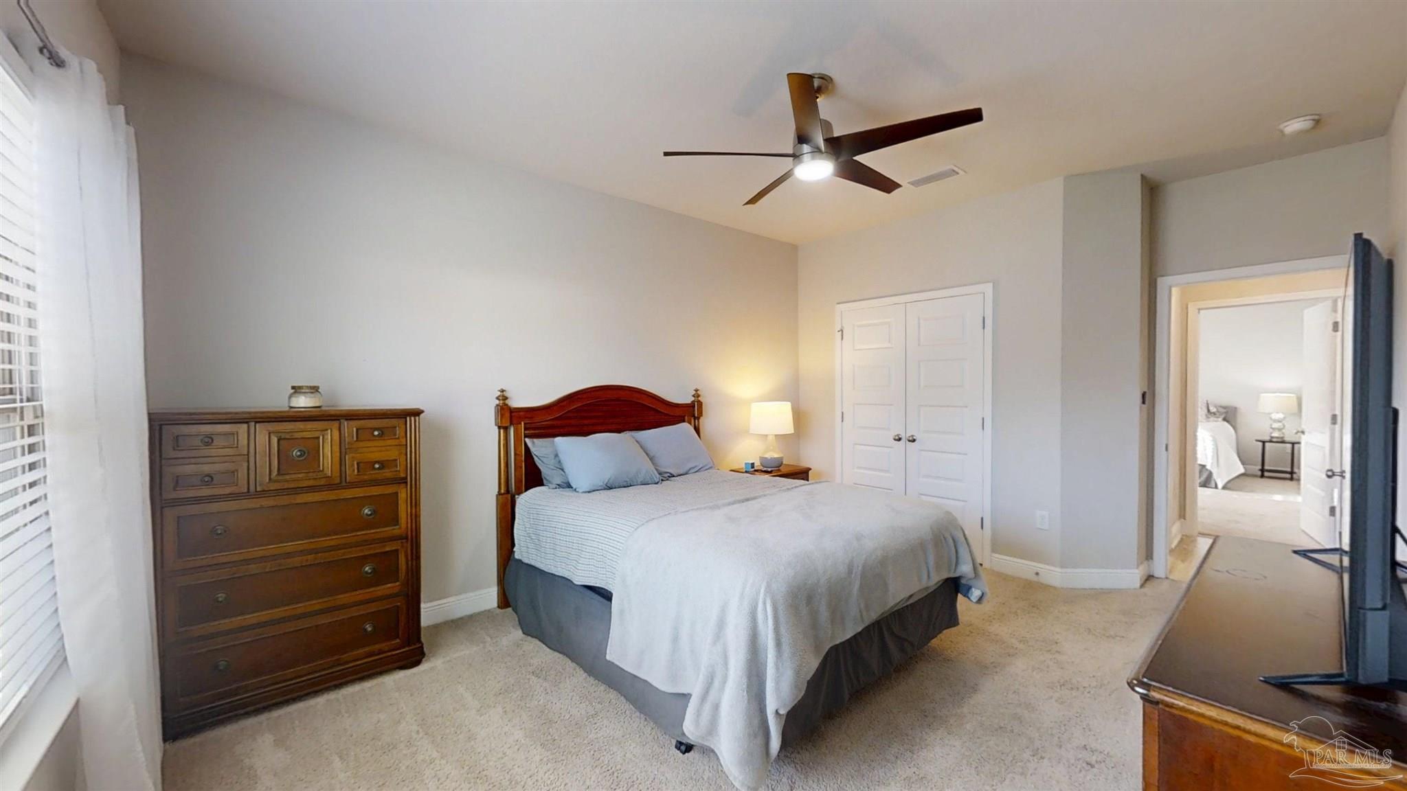 421 Apollo Avenue Gulf Shores, AL 36542 - Photo 44 of 72 a bedroom with a bed and a flat tv screen on the dresser