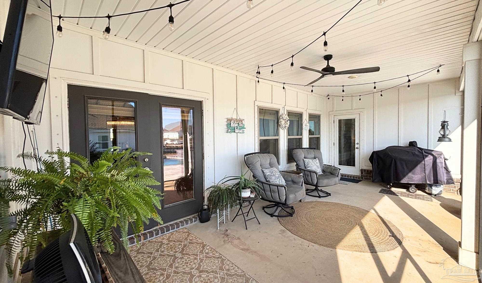 421 Apollo Avenue Gulf Shores, AL 36542 - Photo 47 of 72 a living room with furniture a flat screen tv and a potted plant
