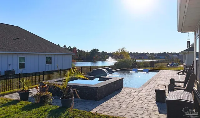 an aerial view of a house with a garden and lake view