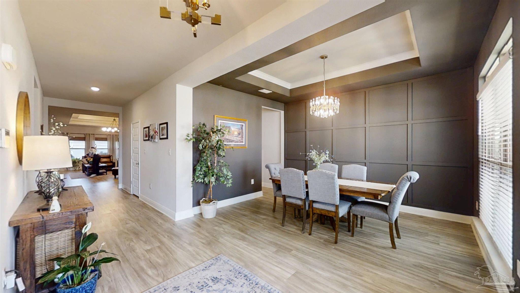421 Apollo Avenue Gulf Shores, AL 36542 - Photo 5 of 72 a view of a dining room with furniture window and wooden floor