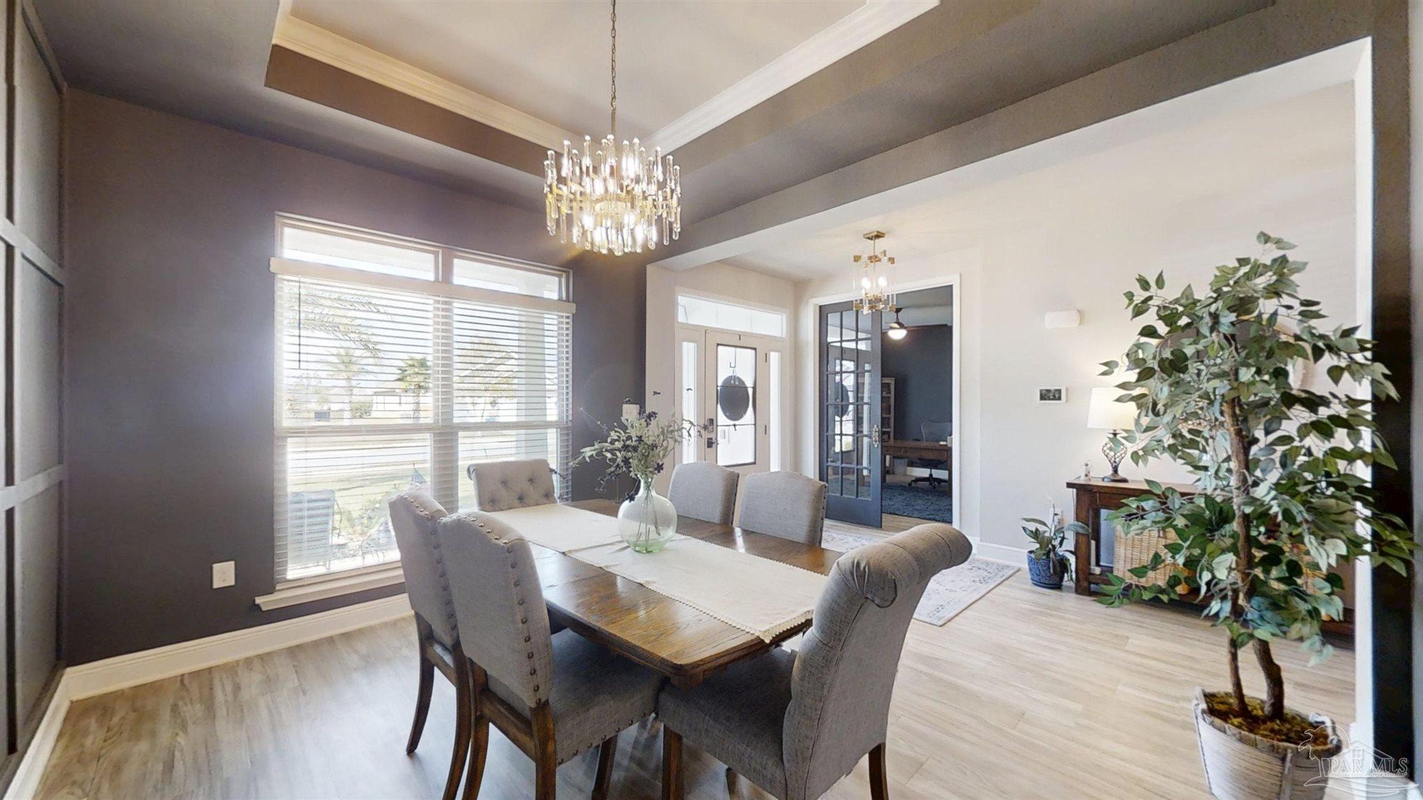 421 Apollo Avenue Gulf Shores, AL 36542 - Photo 7 of 72 a view of a dining room with furniture window and wooden floor