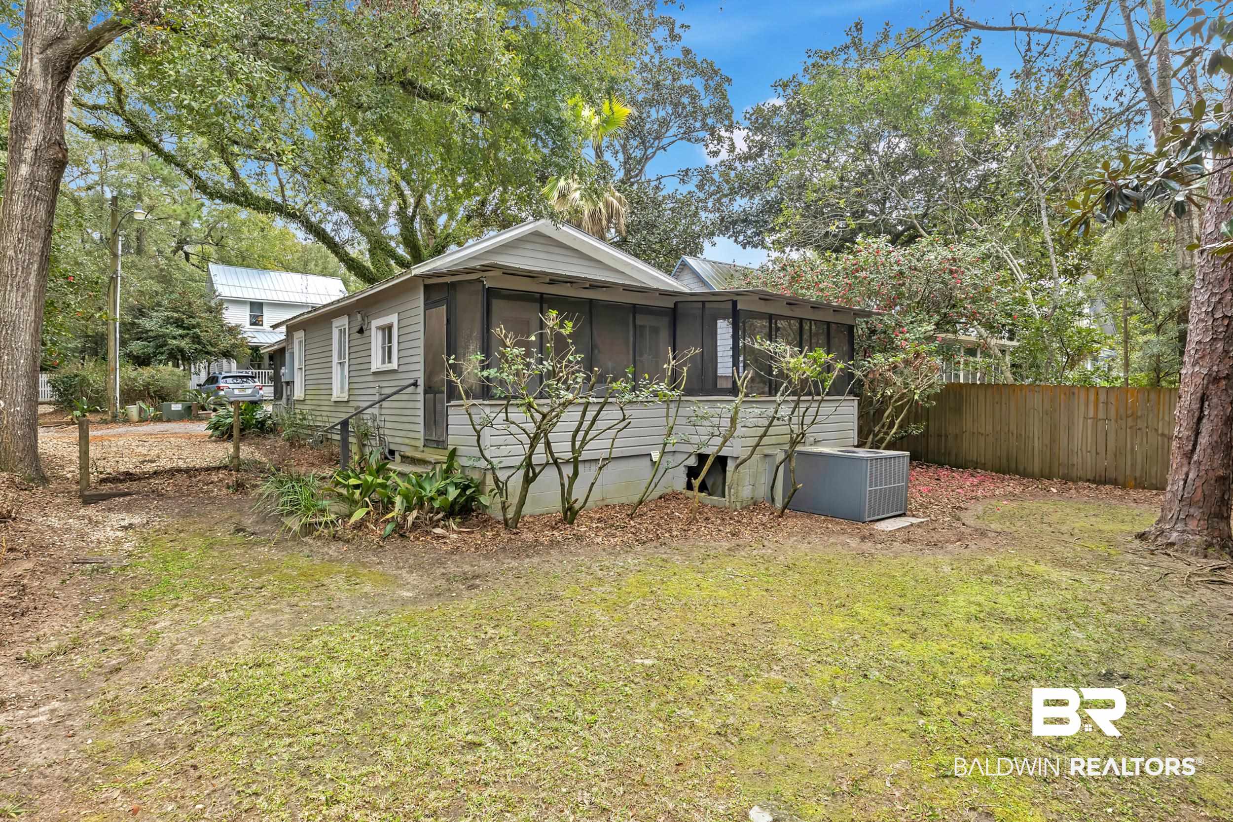55 Boise Lane Fairhope, AL 36532 - Photo 12 of 24 Exterior space with cooling unit, screened porch, fence, and a lawn