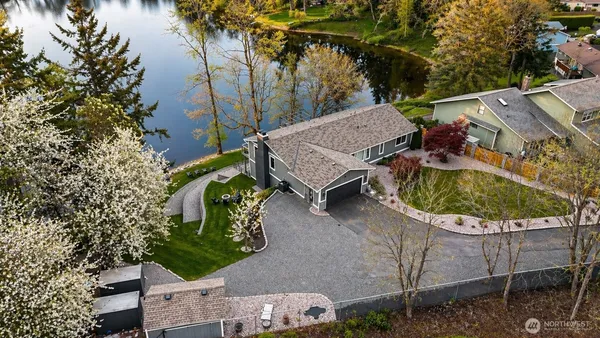 a view of a house with pool and sitting area