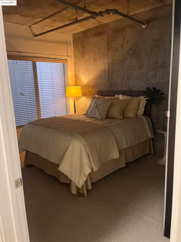 a bed sitting in a bedroom next to a window