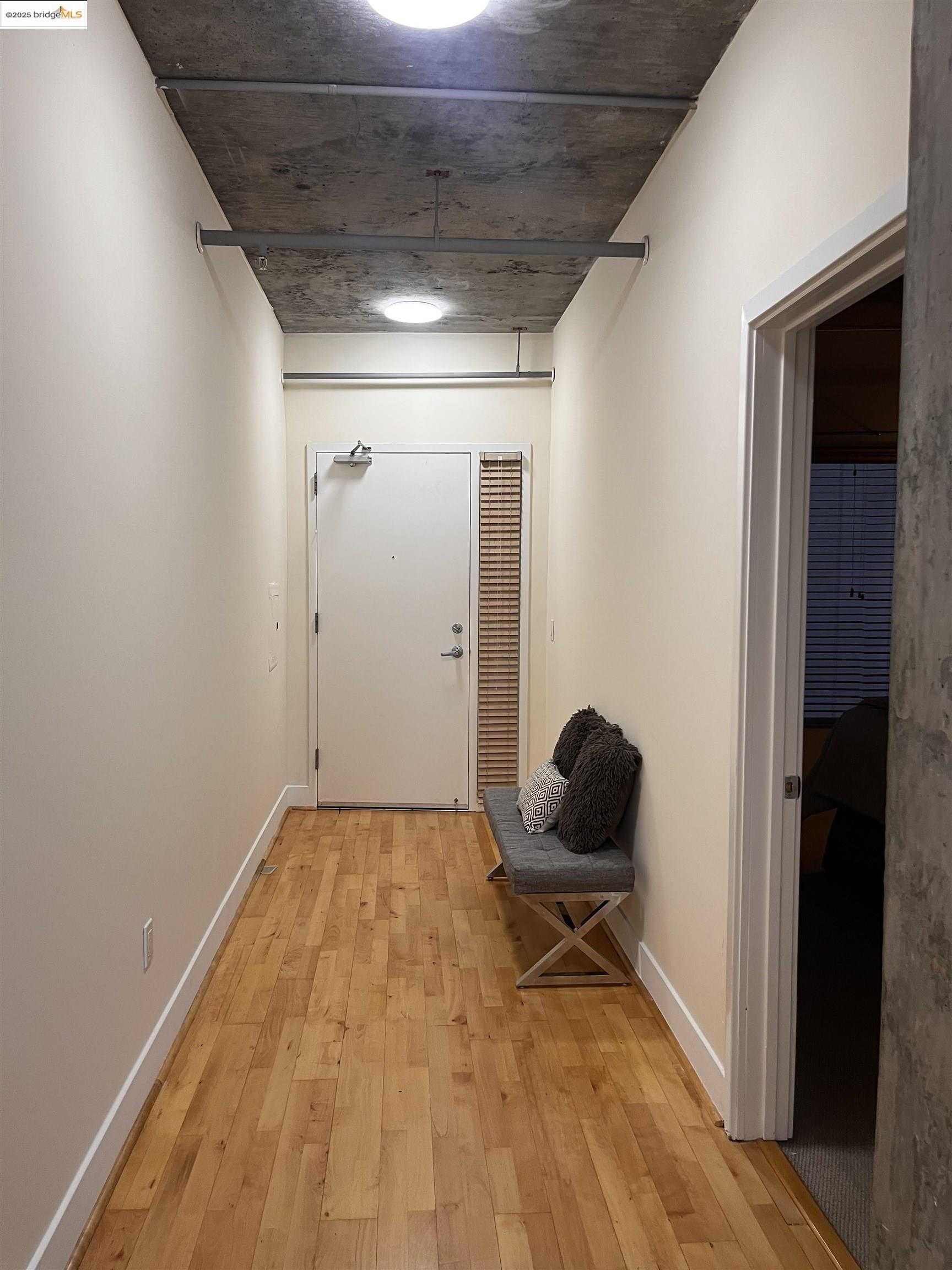 311 Oak Street, Unit 724 Oakland, CA 94607 - Photo 14 of 16 a view of a livingroom with wooden floor and gym equipment
