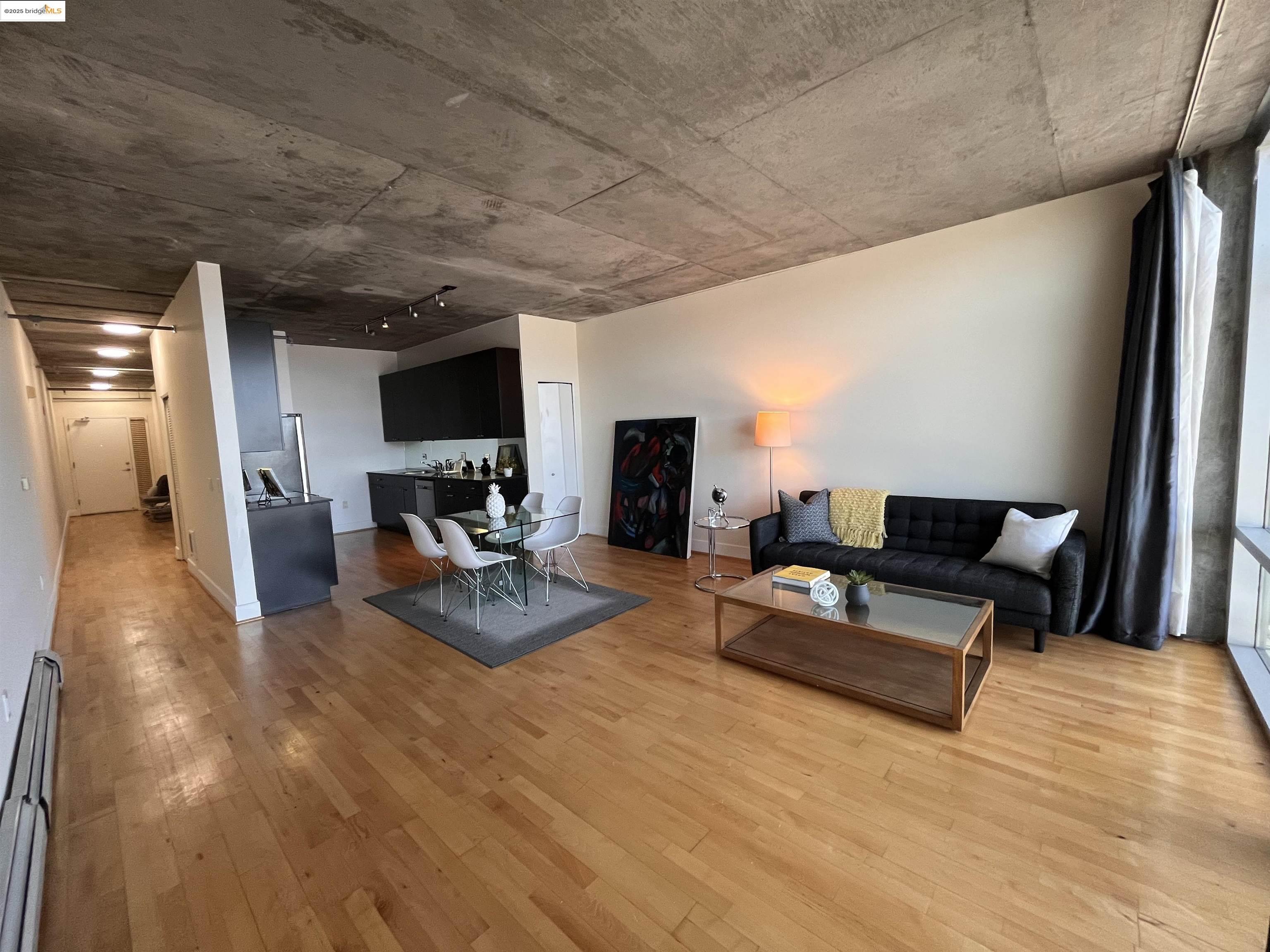 311 Oak Street, Unit 724 Oakland, CA 94607 - Photo 7 of 16 a living room with furniture and a fireplace