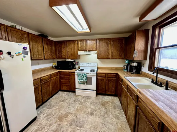 a kitchen with a stove sink and a refrigerator