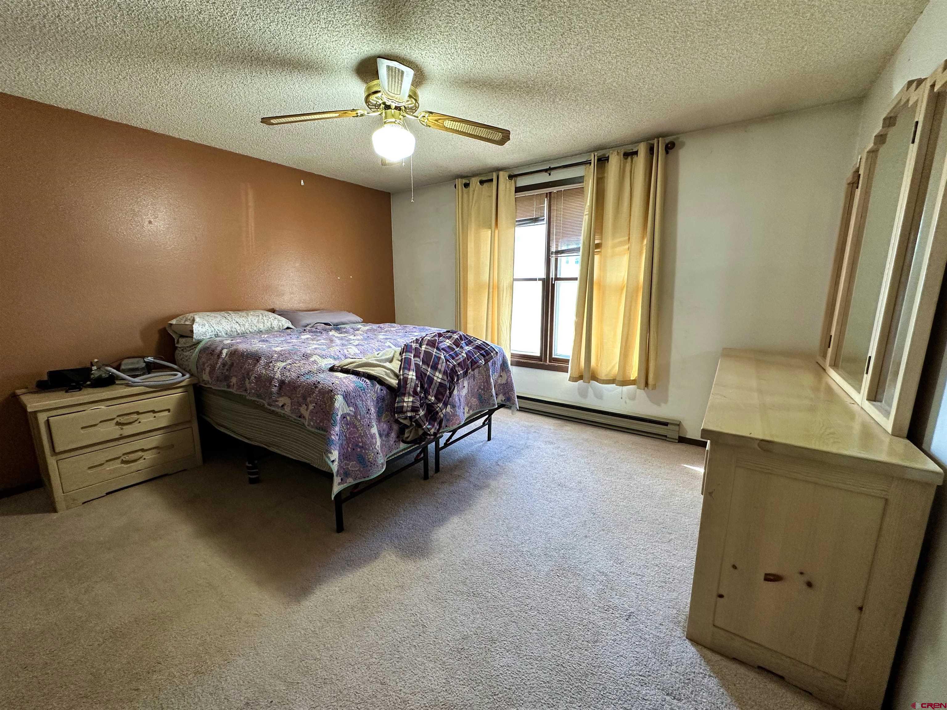 9437 County Road 76 Ohio City, CO 81239 - Photo 13 of 29 a spacious bedroom with a bed and a dresser