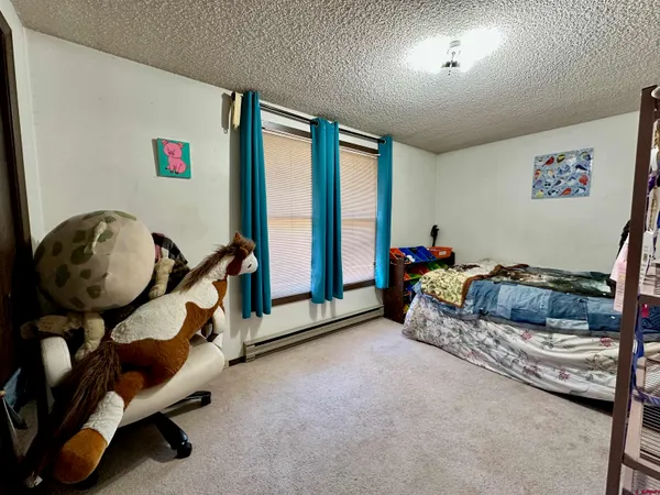 a bed room with a bed and a window