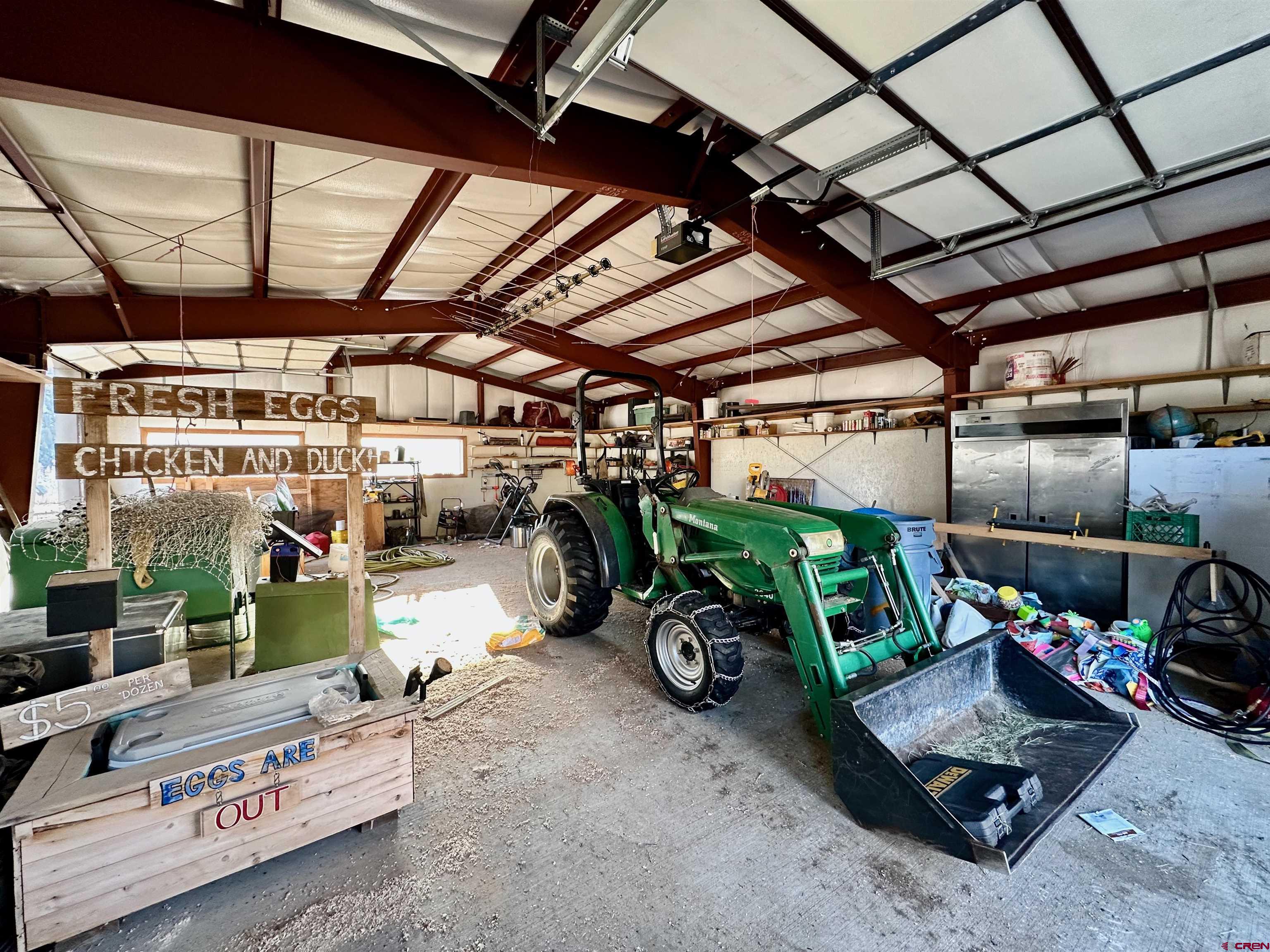 9437 County Road 76 Ohio City, CO 81239 - Photo 17 of 29 a view of a garage with a bike and wooden fence