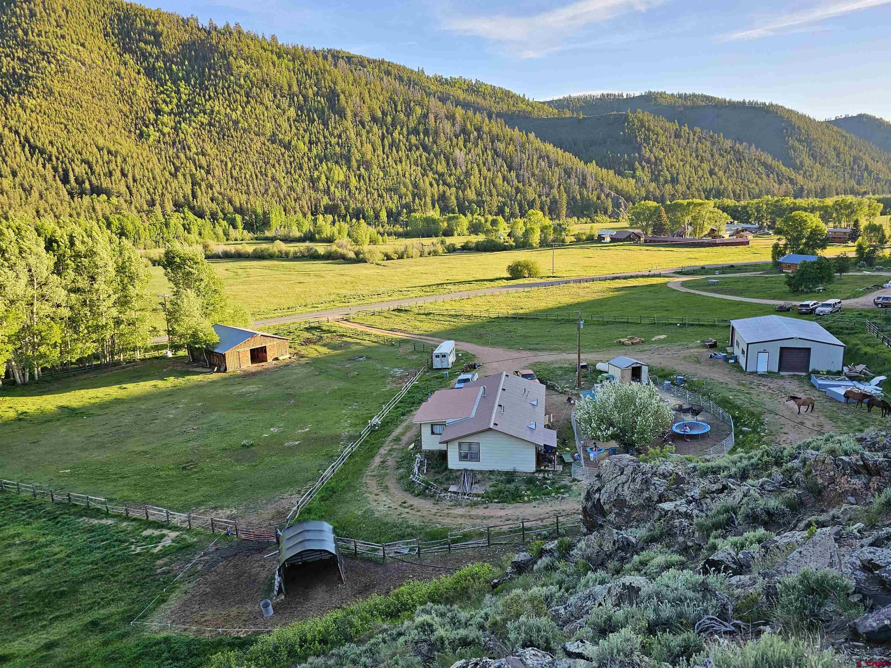 9437 County Road 76 Ohio City, CO 81239 - Photo 3 of 29 an aerial view of a residential houses with outdoor space and trees all around