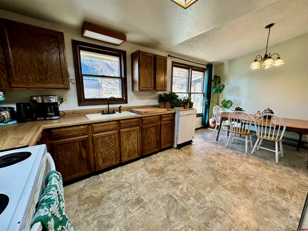 a kitchen with lots of counter top space and dining table