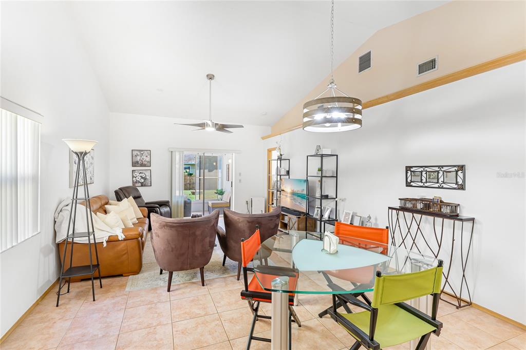 4537 South Lockwood Ridge Road Sarasota, FL 34231 - Photo 4 of 22 a dining room with furniture a chandelier and wooden floor
