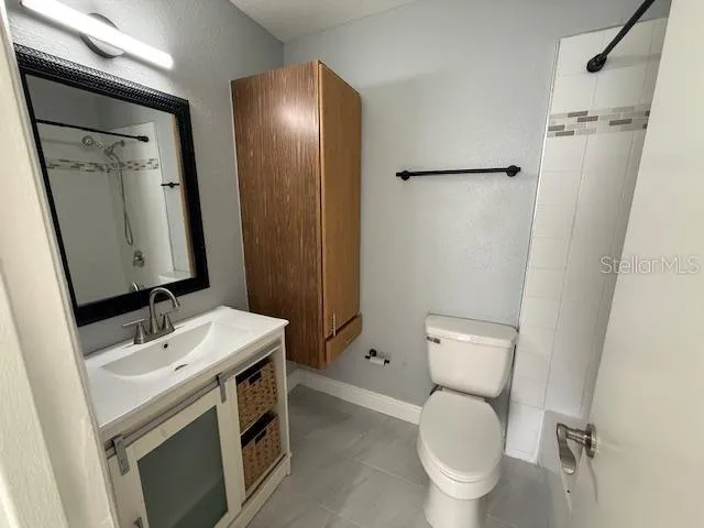 a bathroom with a toilet sink and a mirror