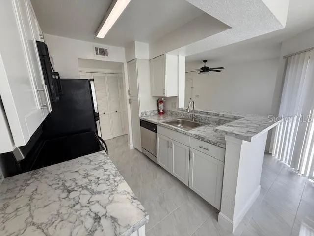 a kitchen with a sink stove and refrigerator