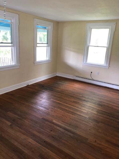 626 Salisbury Road Sheffield, MA 01257 - Photo 2 of 7 an empty room with wooden floor and windows