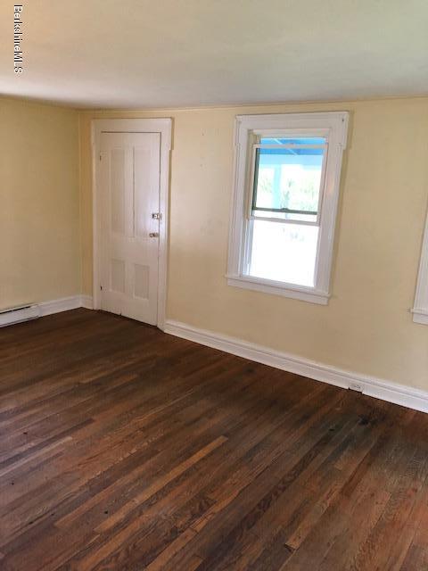 626 Salisbury Road Sheffield, MA 01257 - Photo 3 of 7 a view of an empty room with wooden floor and a window