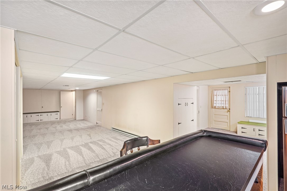 271 Manor Avenue Northwest Canton, OH 44708 - Photo 18 of 26 Game room featuring a drop ceiling, carpet floors, and baseboard heating