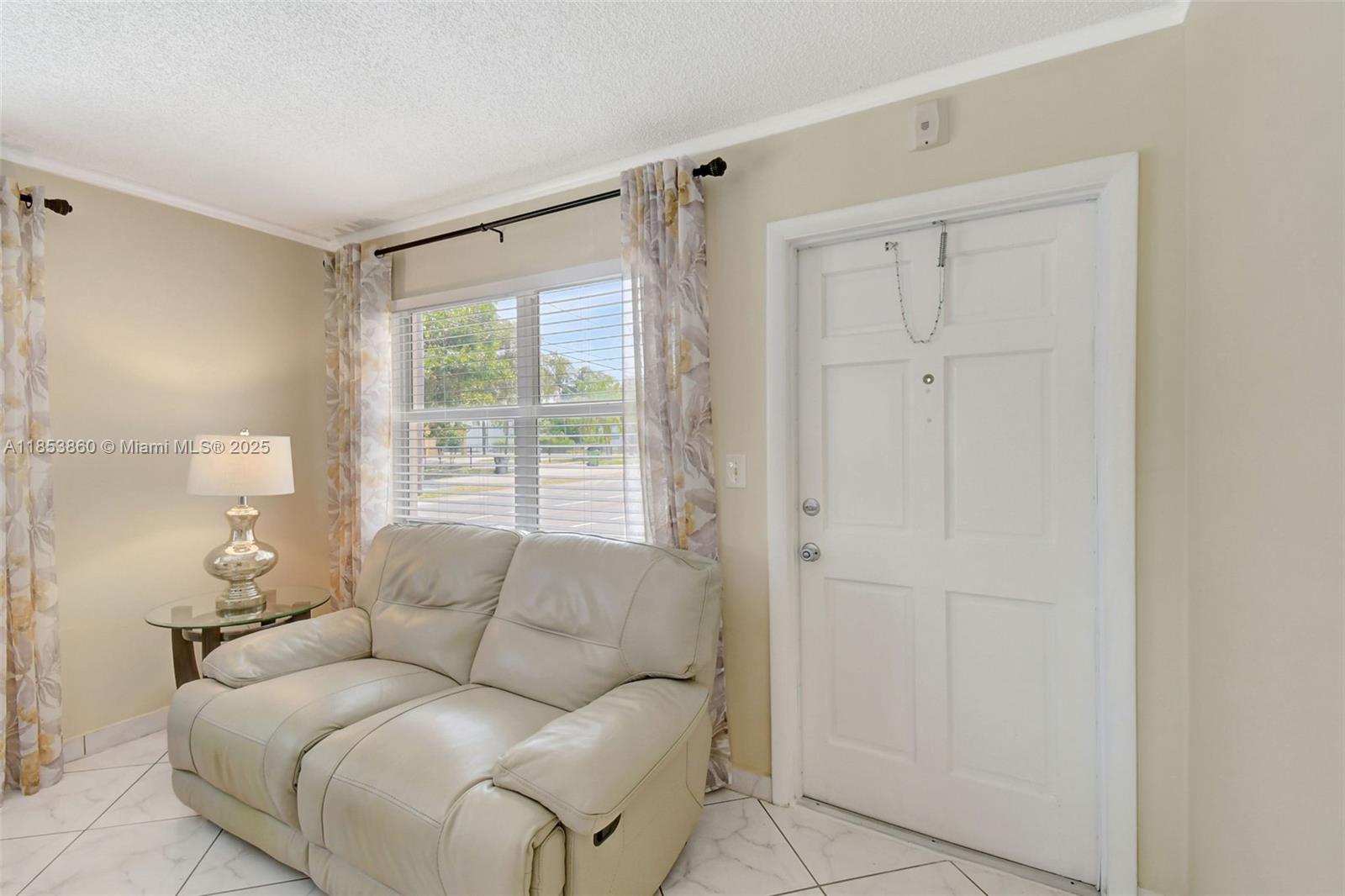 415 Northeast 2nd Street, Unit 124 Hallandale Beach, FL 33009 - Photo 11 of 36 a living room with furniture and a window