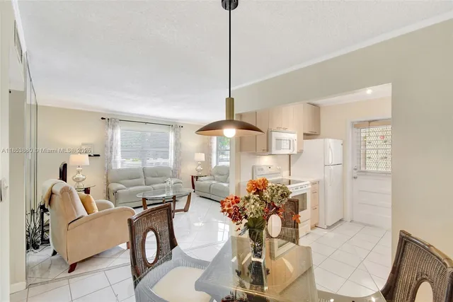 a dining room with furniture a chandelier and window