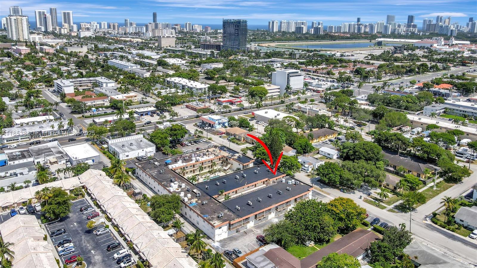 415 Northeast 2nd Street, Unit 124 Hallandale Beach, FL 33009 - Photo 2 of 36 an aerial view of residential building with green space