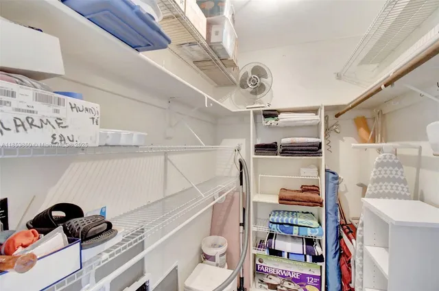 a bedroom with a large bed and a large window