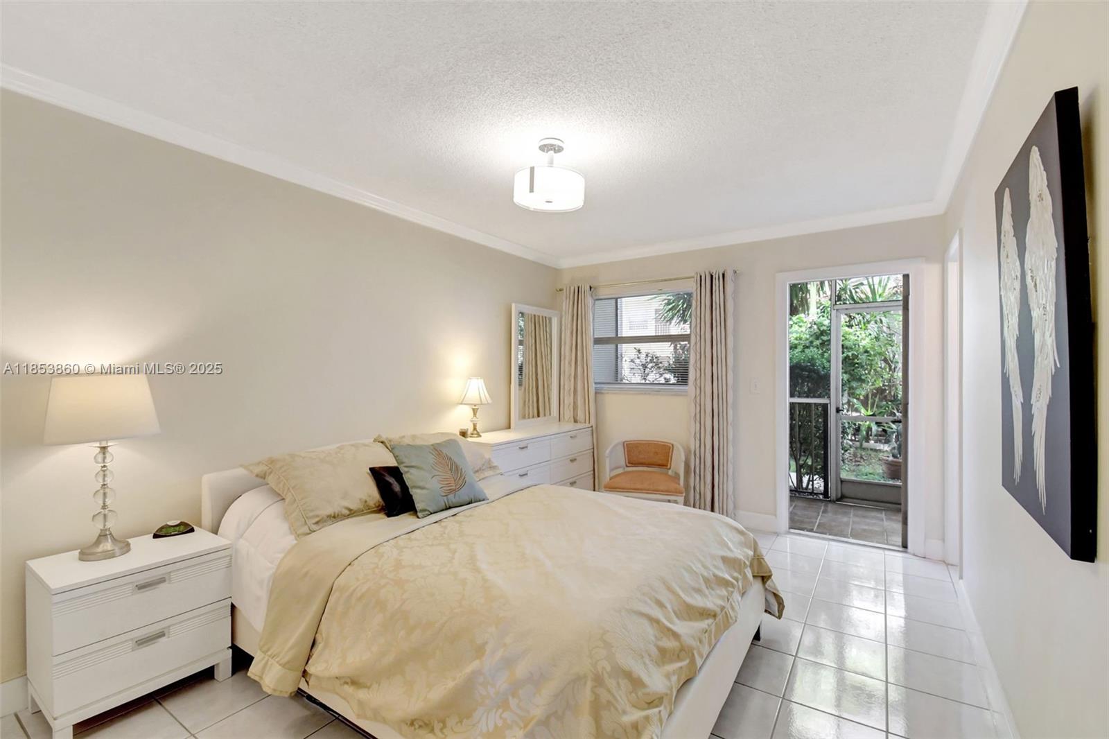 415 Northeast 2nd Street, Unit 124 Hallandale Beach, FL 33009 - Photo 23 of 36 a bedroom with a large bed and a large window