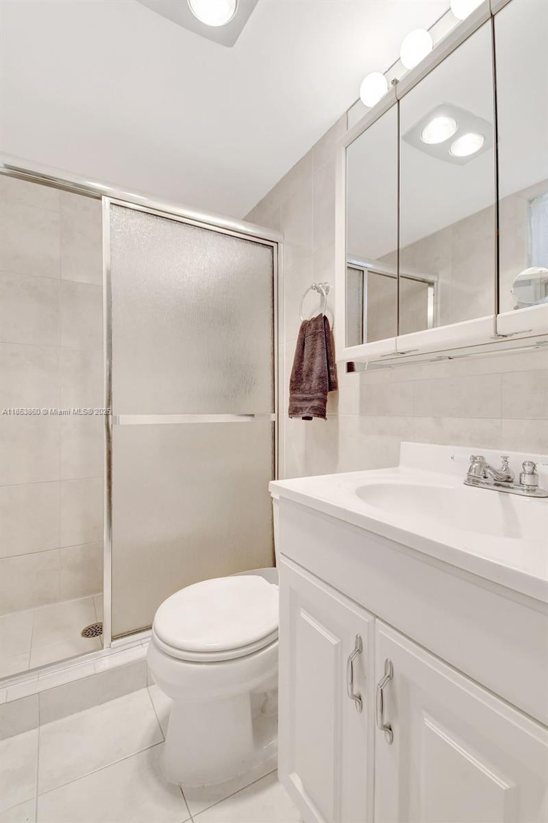 415 Northeast 2nd Street, Unit 124 Hallandale Beach, FL 33009 - Photo 27 of 36 a bathroom with a sink a toilet and shower
