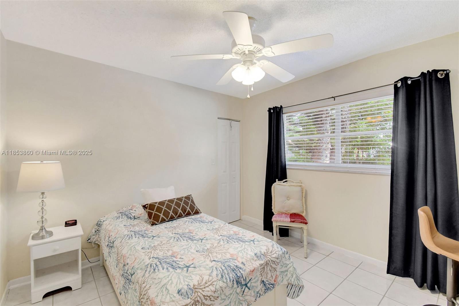 415 Northeast 2nd Street, Unit 124 Hallandale Beach, FL 33009 - Photo 28 of 36 a bedroom with a bed and a window