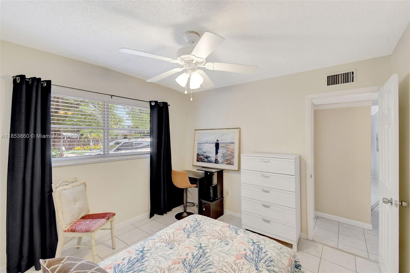 415 Northeast 2nd Street, Unit 124 Hallandale Beach, FL 33009 - Photo 29 of 36 a bed room with a bed and a television