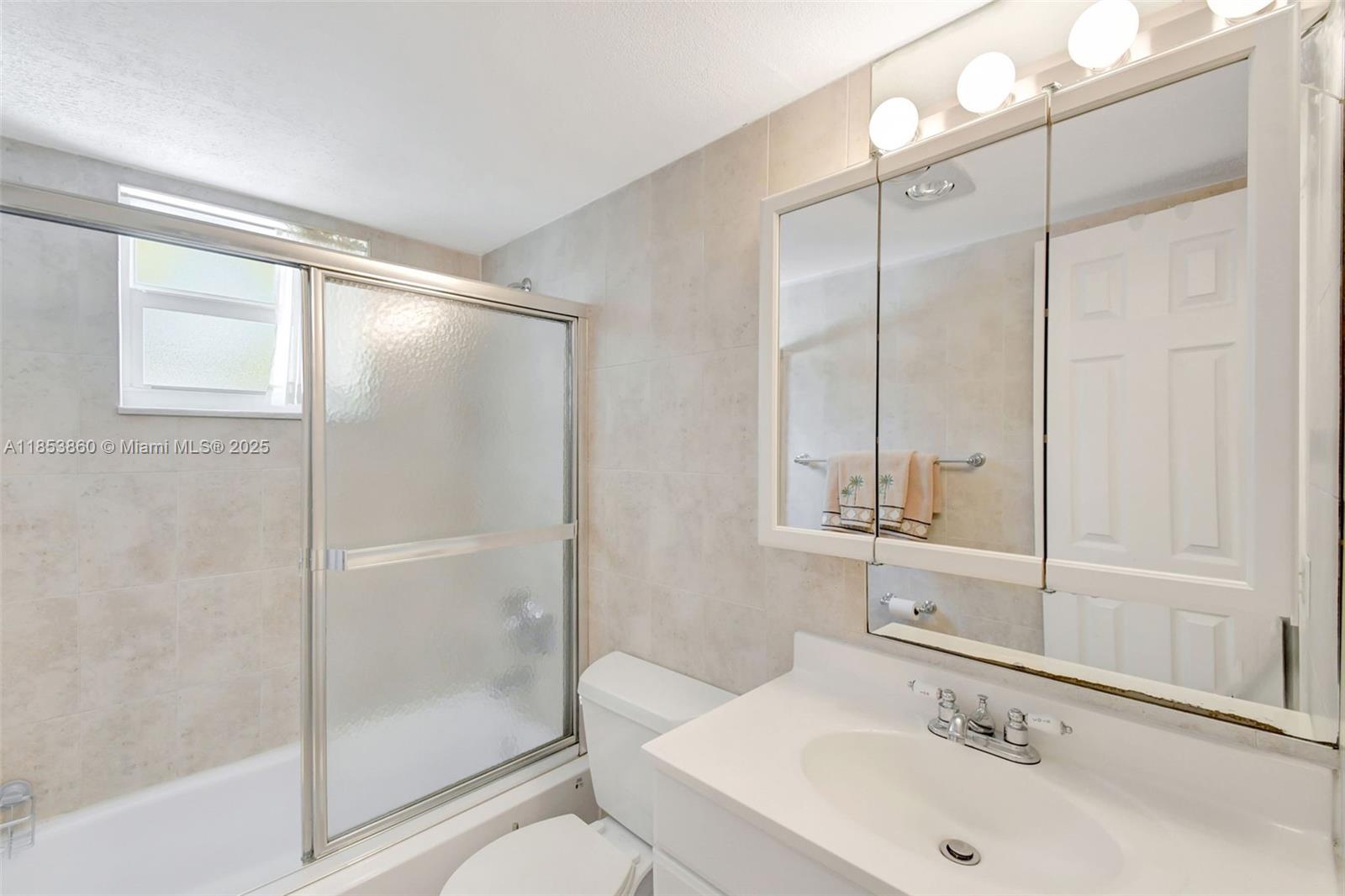 415 Northeast 2nd Street, Unit 124 Hallandale Beach, FL 33009 - Photo 31 of 36 a bathroom with a sink and a mirror