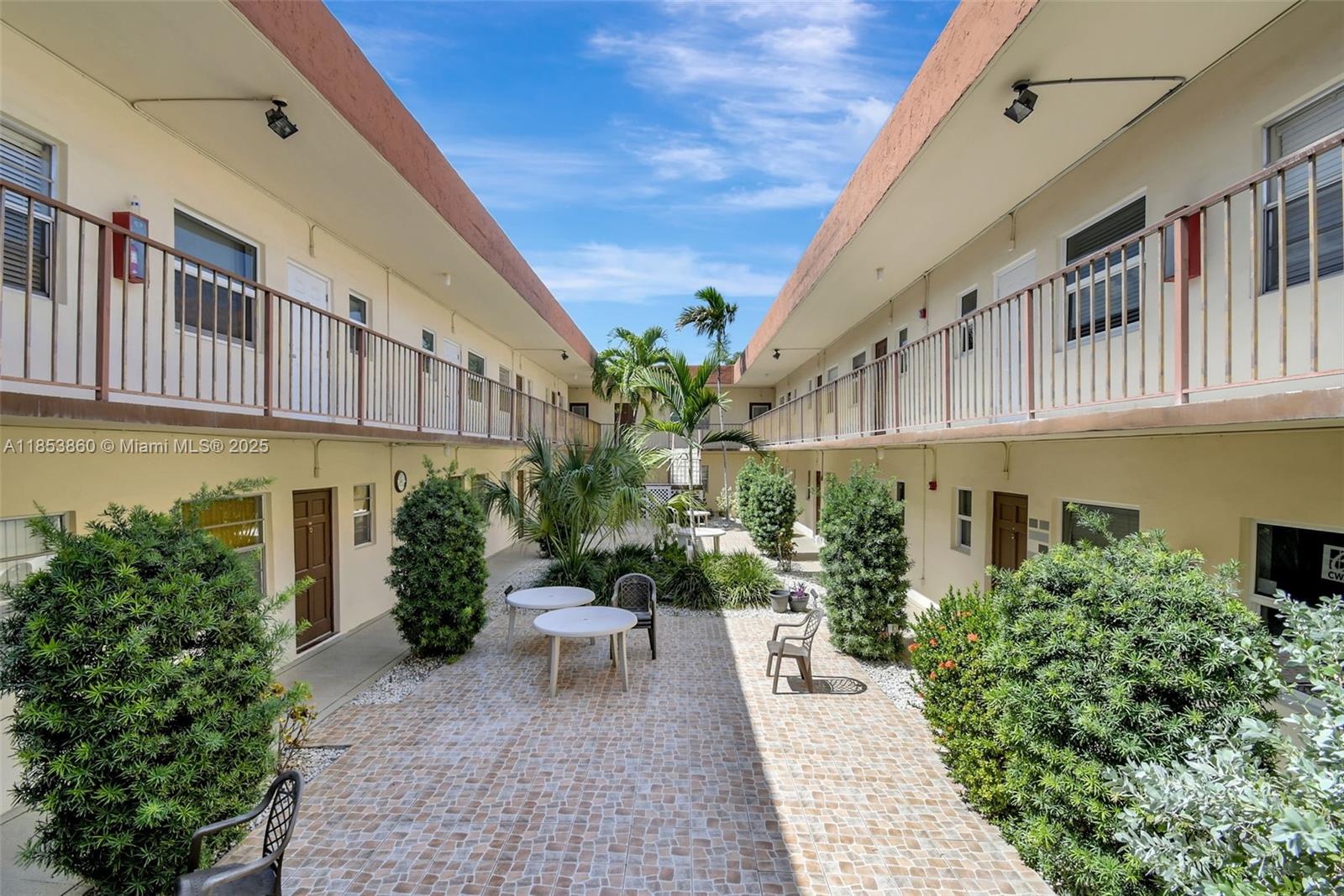 415 Northeast 2nd Street, Unit 124 Hallandale Beach, FL 33009 - Photo 10 of 36 a view of a patio with couches and potted plants