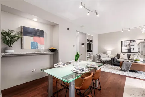 a living room with stainless steel appliances kitchen island granite countertop furniture and a kitchen view
