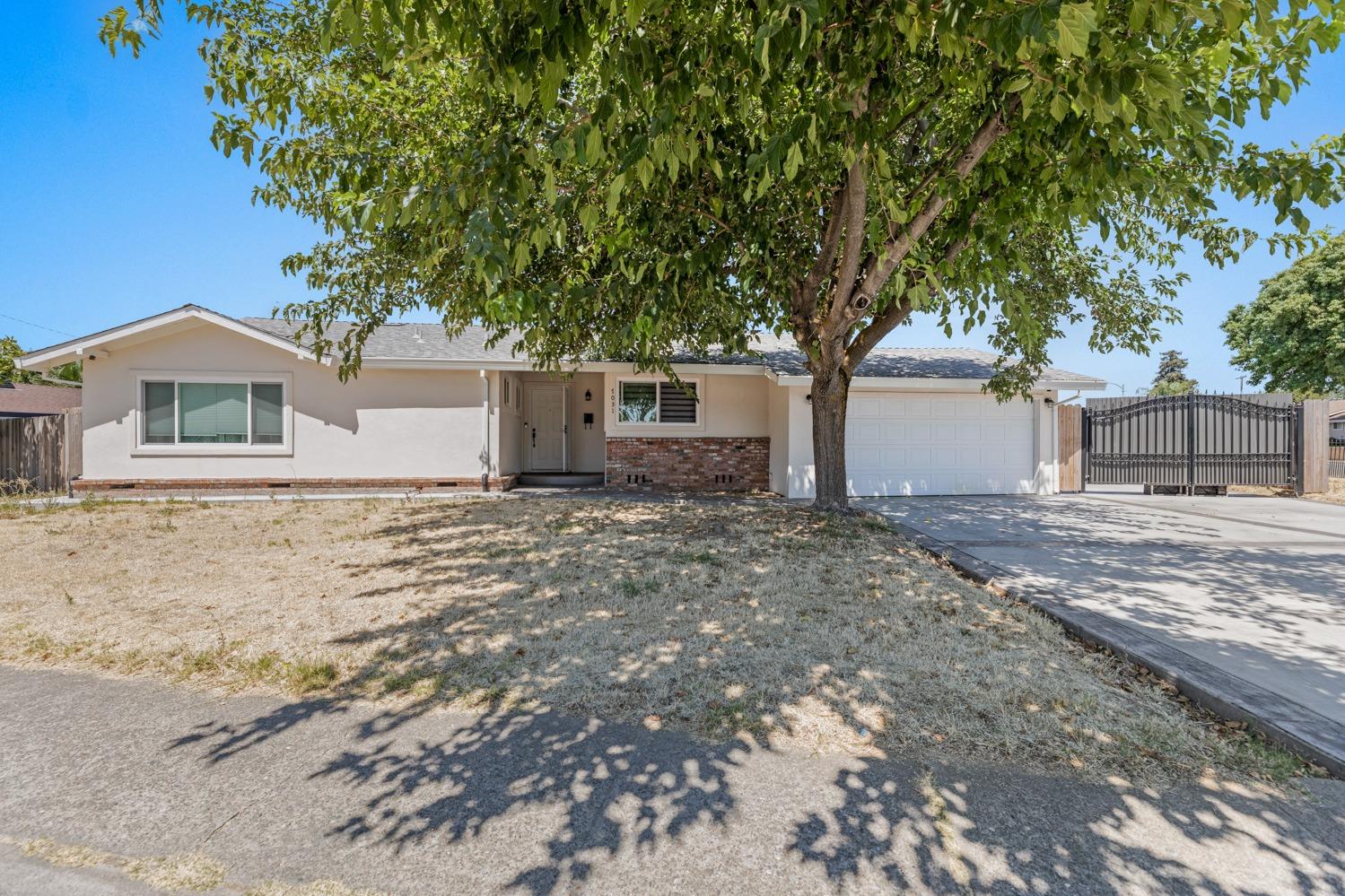 7031 Auburn Boulevard Citrus Heights, CA 95621 - Photo 1 of 1 a front view of a house with a yard and garage
