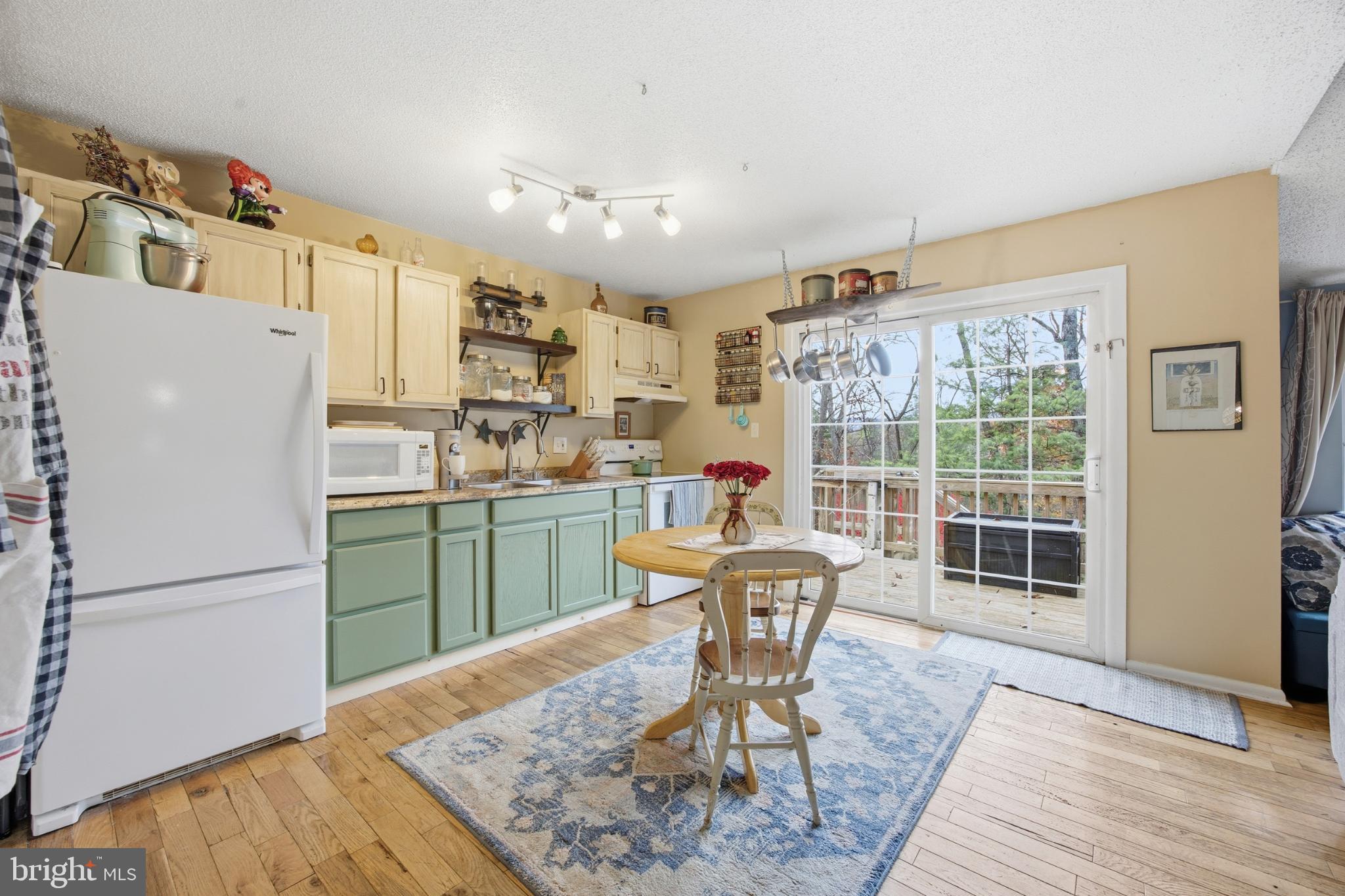128 Hemlock Lane Gerrardstown, WV 25420 - Photo 14 of 44 a kitchen with refrigerator and chairs