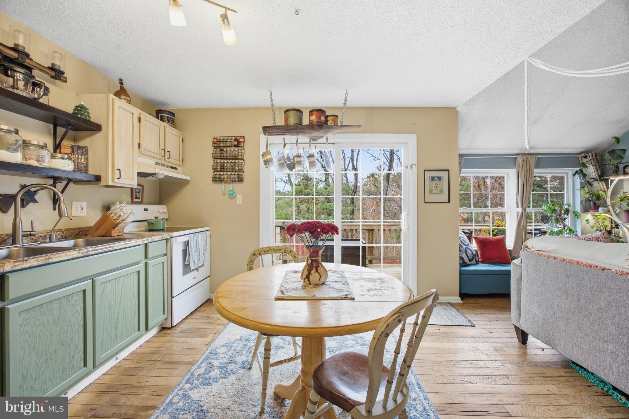 128 Hemlock Lane Gerrardstown, WV 25420 - Photo 17 of 44 a kitchen with a dining table chairs and chandelier