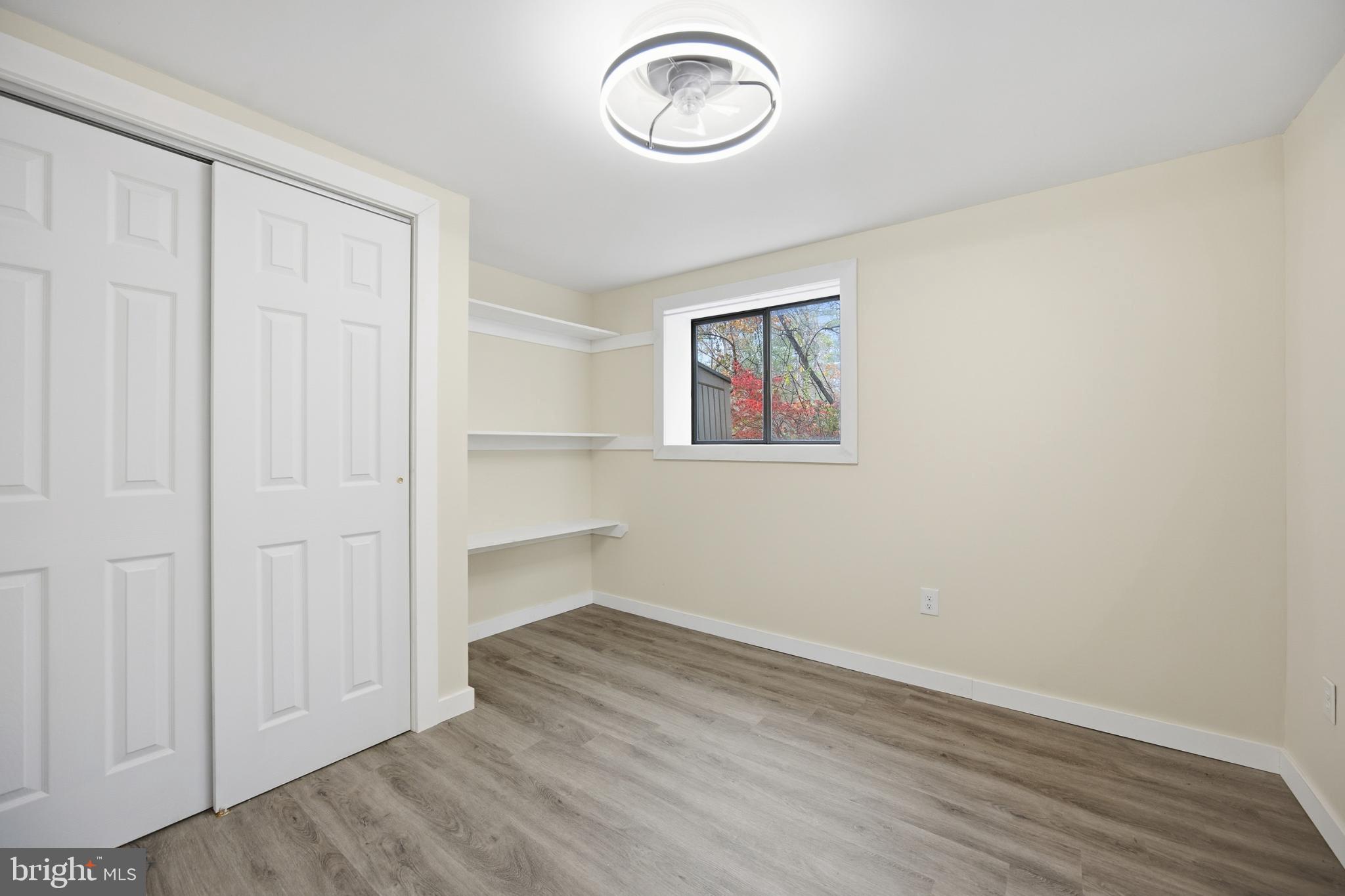 128 Hemlock Lane Gerrardstown, WV 25420 - Photo 25 of 44 an empty room with wooden floor and windows