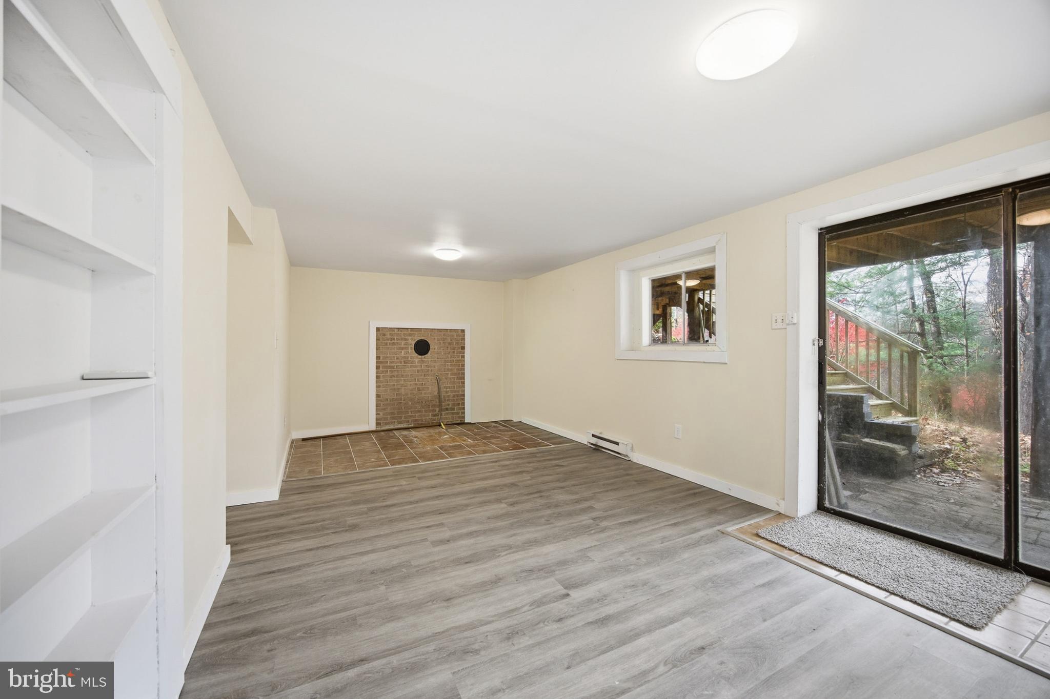 128 Hemlock Lane Gerrardstown, WV 25420 - Photo 29 of 44 a view of an empty room with wooden floor and a window