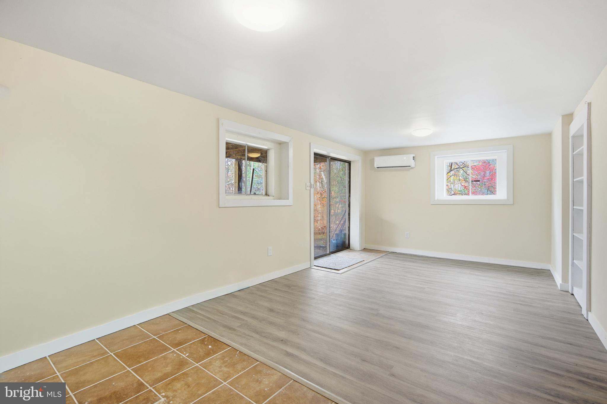 128 Hemlock Lane Gerrardstown, WV 25420 - Photo 31 of 44 an empty room with wooden floor and windows
