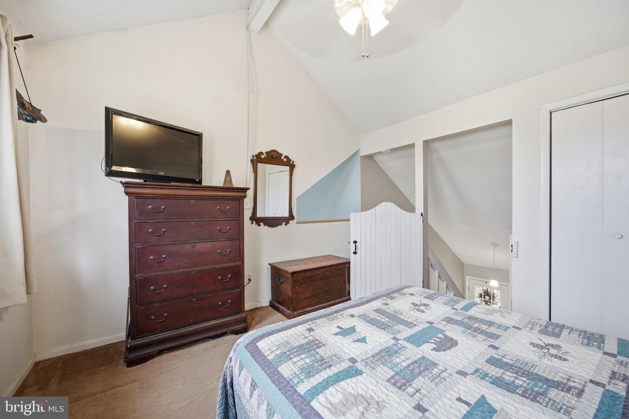 128 Hemlock Lane Gerrardstown, WV 25420 - Photo 6 of 44 a bedroom with a bed and a flat screen tv