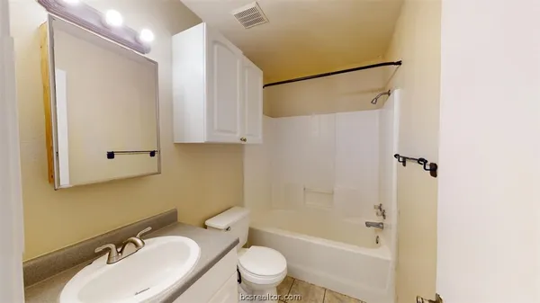 a bathroom with a sink toilet tub and shower