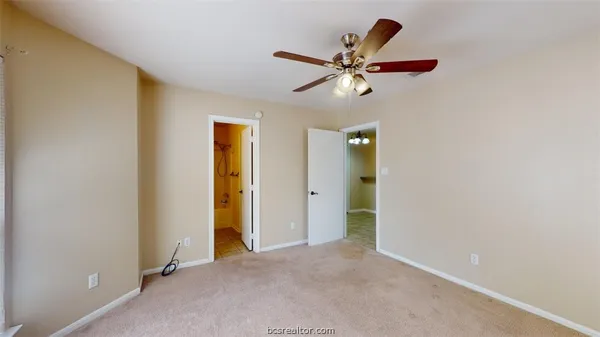 a view of a livingroom with a ceiling fan and window