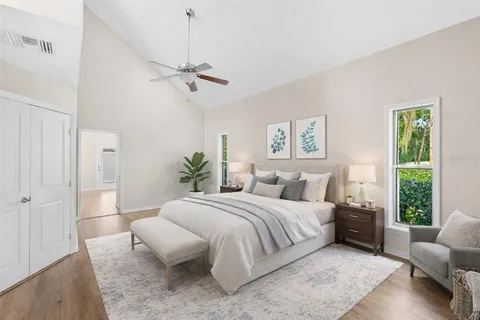 a bedroom with a bed couch and a window