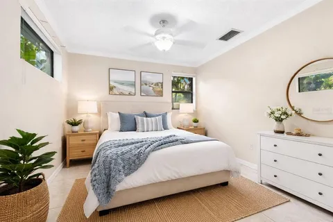 an empty room with windows and ceiling fan