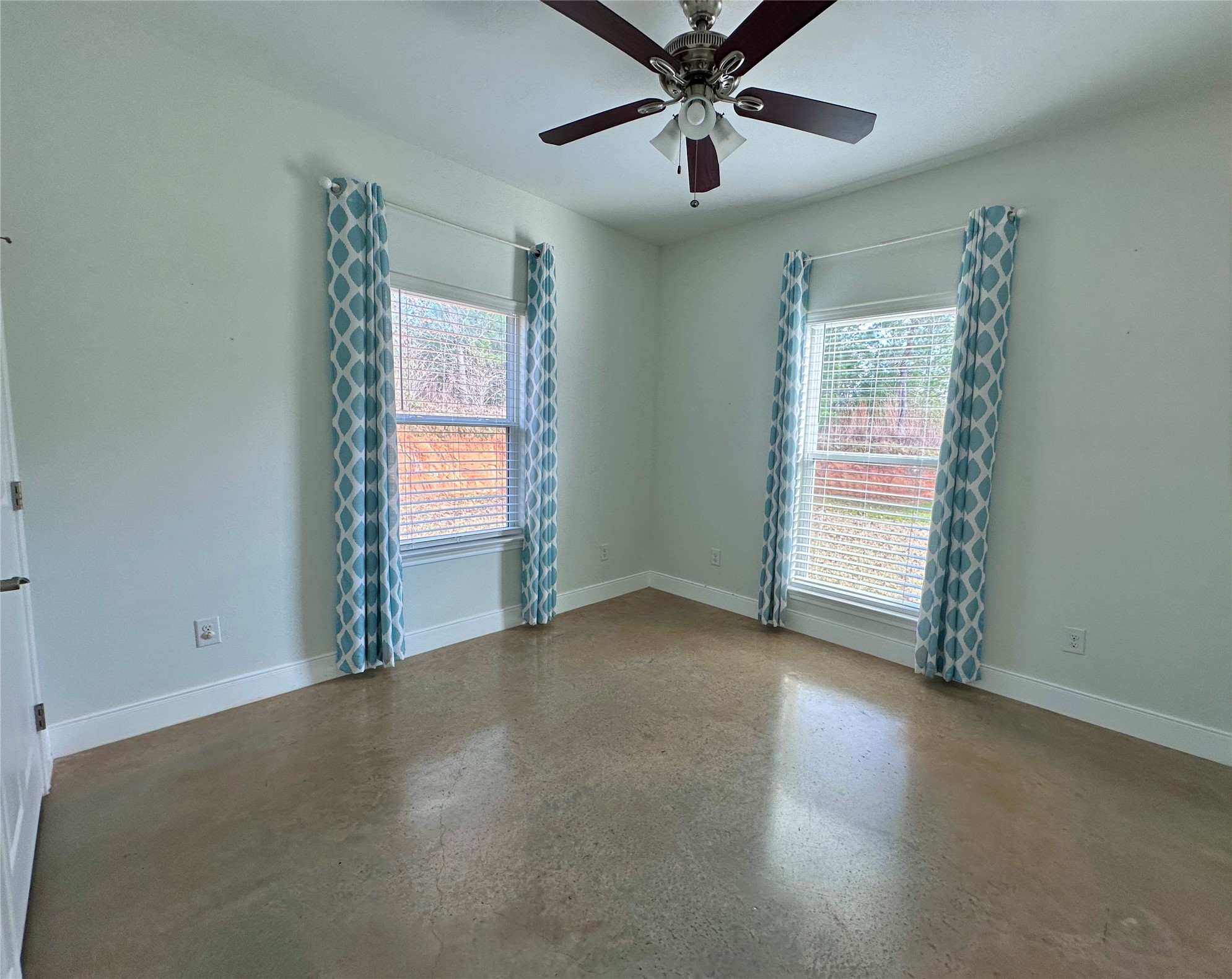 124 Pine Path Bastrop, TX 78602 - Photo 18 of 31 Spare bedroom with finished concrete floors, ceiling fan