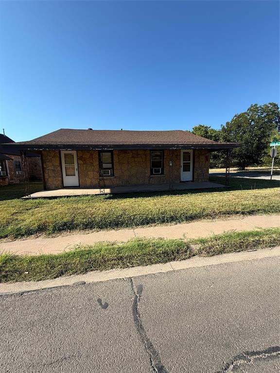 a front view of house with yard and car parked
