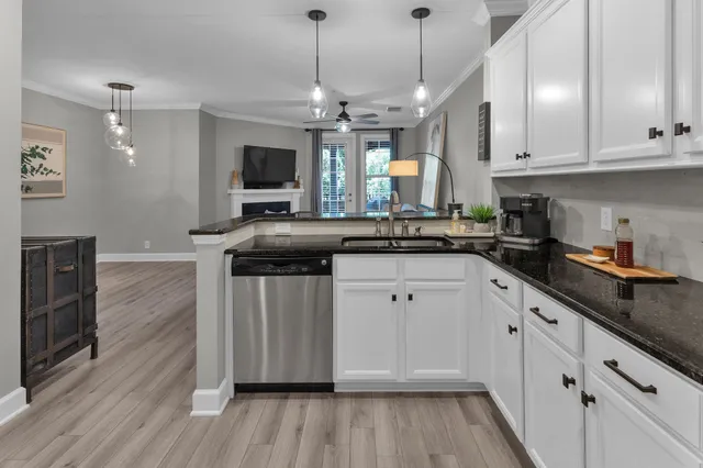 a kitchen with granite countertop a sink and cabinets